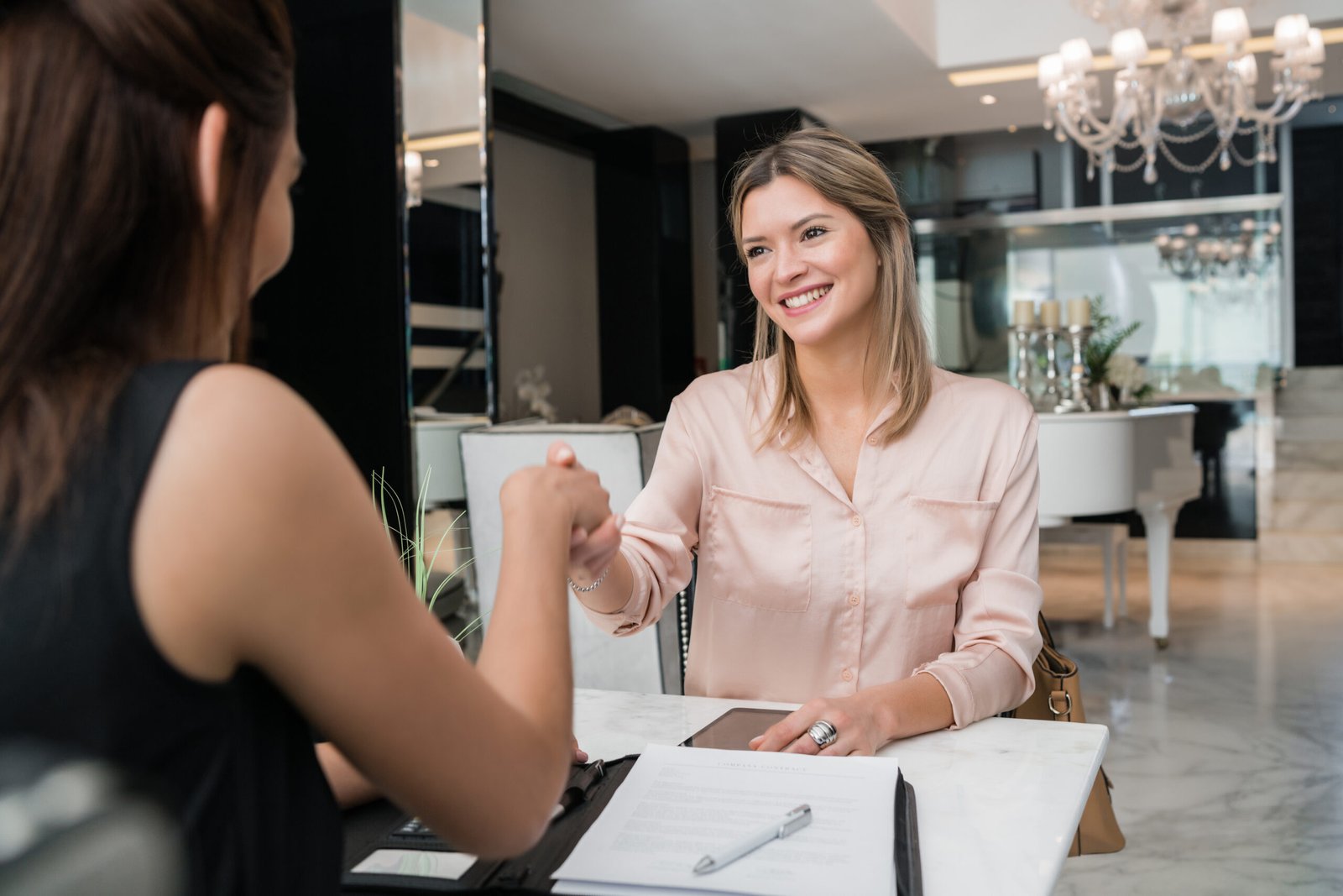 two businesswomen having meeting at hotel lobby.